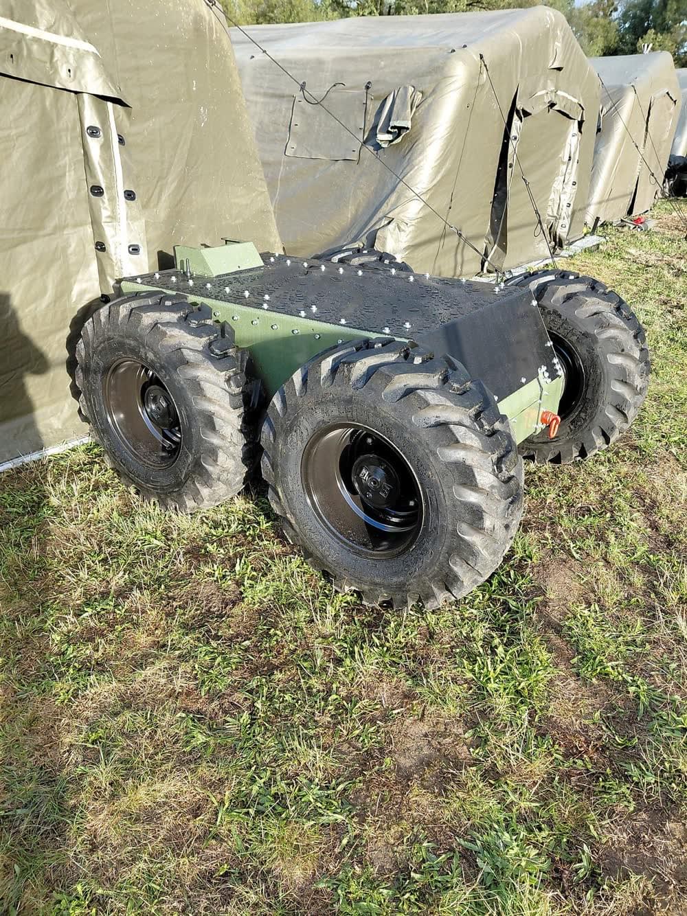 WF25 prototype with 18-inch wheels next to field tents